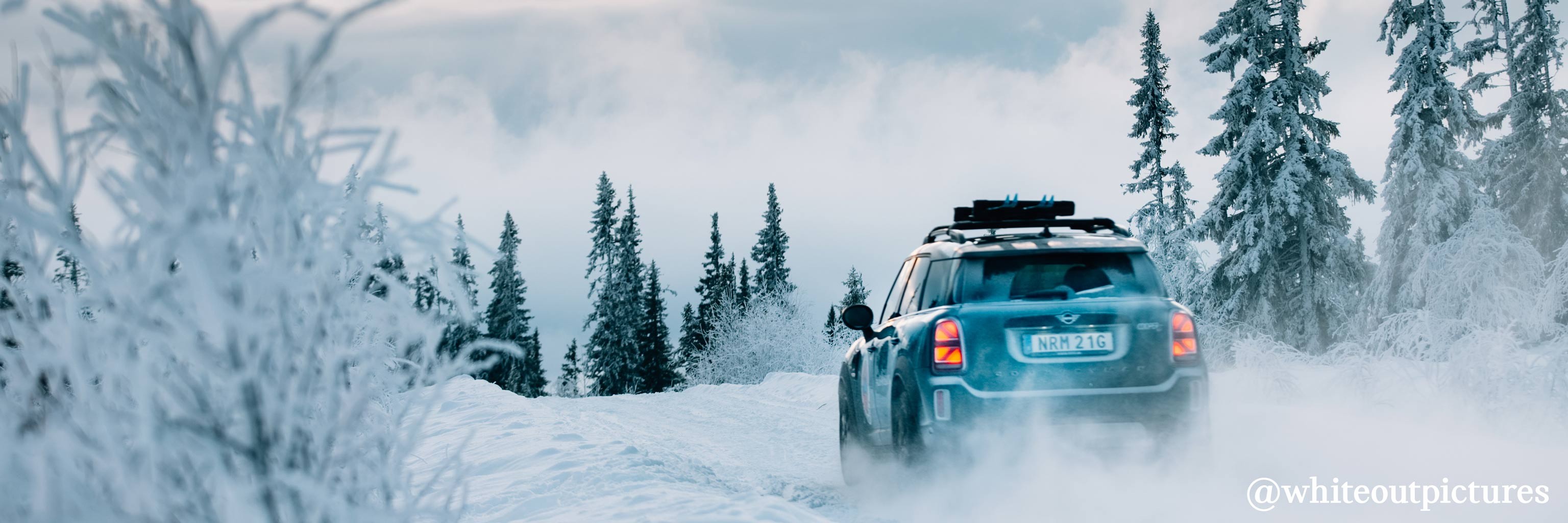 MINI COOPER COUNTRYMAN outdoors in the snow rear view